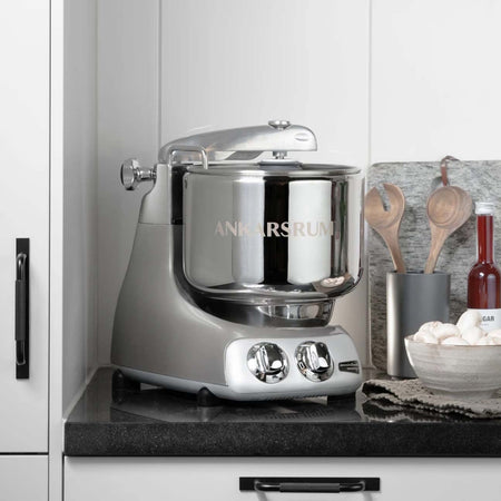 Ankarsrum stand mixer in jubilee silver shown on a countertop.